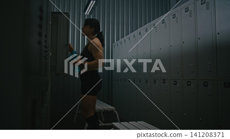Determined Woman Overcoming Fatigue and Getting Ready for Gym Session Determined Woman Overcoming Fatigue and Getting Ready for Gym Session 141208371