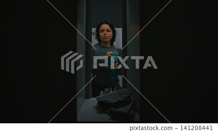 Fit Woman Getting Ready for Fitness Training in Modern Locker Room 141208441
