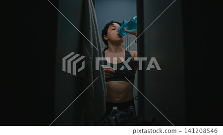 Young Female Athlete Recovers in Modern Locker Room After Workout Young Female Athlete Recovers in Modern Locker Room After Workout 141208546
