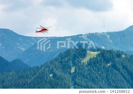 Bansko, Bulgaria, red emergency medical service helicopter flying, green Pirin mountains banner 141208652