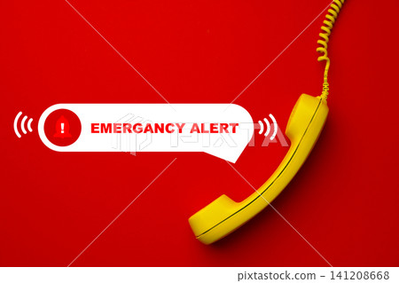 Emergency service response alert with yellow phone on red background during a crisis situation Emergency service response alert with yellow phone on red background during a crisis situation 141208668