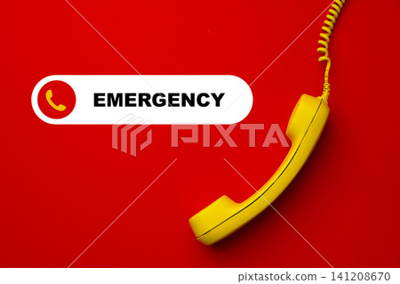 Emergency service phone on red background with yellow receiver for urgent calls and assistance 141208670