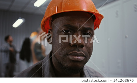 Intense Portrait of Factory Worker Looking Intently at Camera Intense Portrait of Factory Worker Looking Intently at Camera 141208676