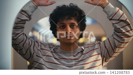Passenger Undergoes Airport Security Screening, Standing Still With Hands Raised in Body Scanner Passenger Undergoes Airport Security Screening, Standing Still With Hands Raised in Body Scanner 141208783