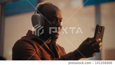African American Man Having Video Call with Family at Airport Terminal African American Man Having Video Call with Family at Airport Terminal 141208806