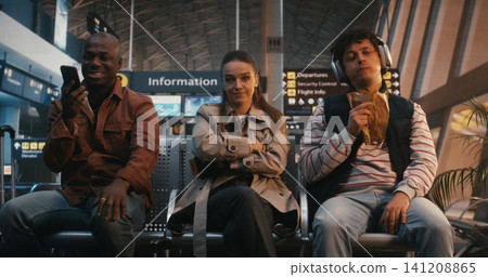 Young Introverted Woman Feeling Anxious in Crowded Airport Terminal Young Introverted Woman Feeling Anxious in Crowded Airport Terminal 141208865