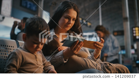 Authentic Moment of Mother Breastfeeding Baby at Airport Departure Gate Authentic Moment of Mother Breastfeeding Baby at Airport Departure Gate 141209037