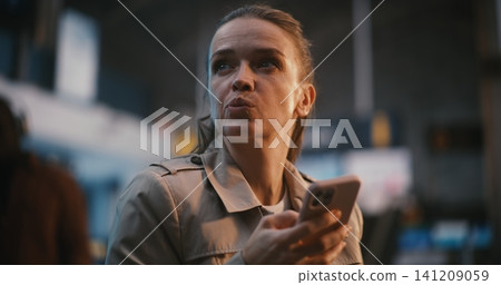 Professional Woman Managing Travel Documents in Airport Terminal Professional Woman Managing Travel Documents in Airport Terminal 141209059