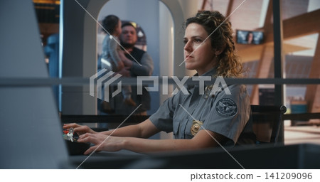 Uniformed Officer Managing Luggage Scanning System at Airport Entrance Uniformed Officer Managing Luggage Scanning System at Airport Entrance 141209096