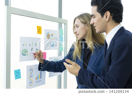 Man and woman businesspeople planning business strategy and shaking hands in office. Business, education and office concept. 141209134