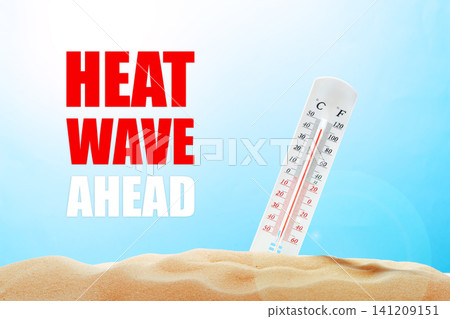 Heat wave warning with thermometer showing high temperatures and sandy background in bright sky Heat wave warning with thermometer showing high temperatures and sandy background in bright sky 141209151