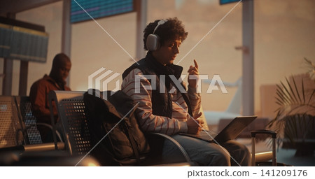 Young Professional Having Business Video Call at Airport with Plane Departing Behind Young Professional Having Business Video Call at Airport with Plane Departing Behind 141209176
