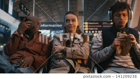 Neurodivergent Woman Experiencing Sensory Overload at Busy Airport Gate Neurodivergent Woman Experiencing Sensory Overload at Busy Airport Gate 141209238