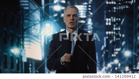 Serious Middle Aged News Correspondent Reporting Live from Urban Location during Nighttime 141209412