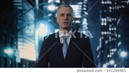 Professional Mature Male Reporter Delivering Urgent News Broadcast on Busy Night City Street Professional Mature Male Reporter Delivering Urgent News Broadcast on Busy Night City Street 141209465
