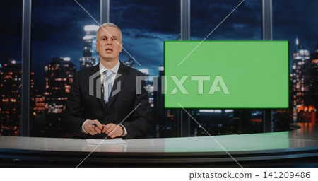 Professional Mature Male News Anchor Sitting at Desk with Green Screen Background for Virtual Studio Professional Mature Male News Anchor Sitting at Desk with Green Screen Background for Virtual Studio 141209486