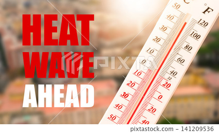 Heatwave warning shows high temperature on thermometer in urban area during sunny day 141209536
