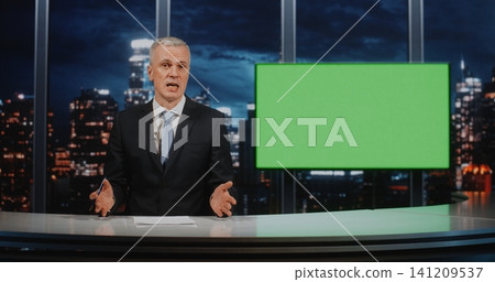 Professional Mature Male News Anchor Sitting at Desk with Green Screen Background for Virtual Studio Professional Mature Male News Anchor Sitting at Desk with Green Screen Background for Virtual Studio 141209537