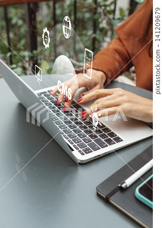 Hands typing on laptop while interacting with a content management system overlay in a workspace Hands typing on laptop while interacting with a content management system overlay in a workspace 141209679