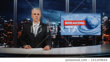 Confident Mature Male Journalist Presenting Urgent News Coverage in Professional Television Studio Confident Mature Male Journalist Presenting Urgent News Coverage in Professional Television Studio 141209684