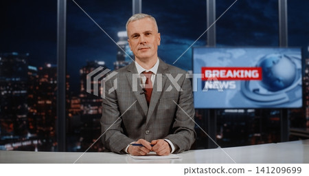 Mature Male News Anchor Hosting 24 7 Live Broadcast with Breaking News Screen 141209699