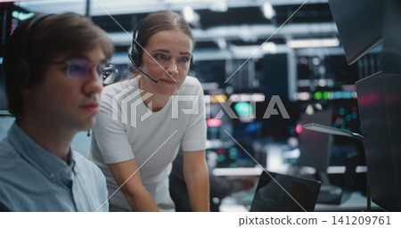 Male and Female Brokers Analyzing Real Time Stock Data Together Male and Female Brokers Analyzing Real Time Stock Data Together 141209761