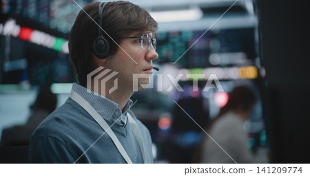 Determined Young Specialist Deeply Engaged in Technical Analysis Determined Young Specialist Deeply Engaged in Technical Analysis 141209774