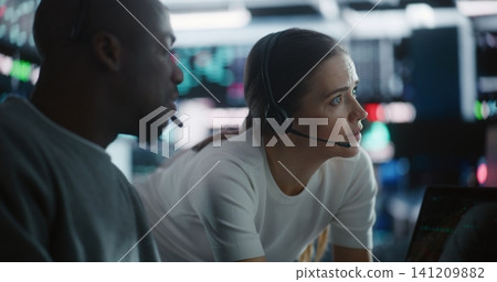 Diverse Team Traders Discussing Urgent Market Strategy During Volatility Diverse Team Traders Discussing Urgent Market Strategy During Volatility 141209882
