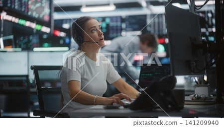 Distressed Female Trader Calling on Desk Phone During Sudden Stock Market Crash Distressed Female Trader Calling on Desk Phone During Sudden Stock Market Crash 141209940