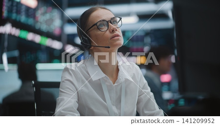 Professional Woman in Glasses and Crisp White Shirt of Active Engagement on Trading Floor 141209952