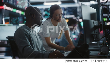 Female Financial Supervisor Mentoring Male Analyst at Stock Exchange Station Female Financial Supervisor Mentoring Male Analyst at Stock Exchange Station 141209955