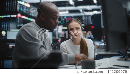 Diverse Professional Team Reviewing Investment Data in Global Brokerage Firm Diverse Professional Team Reviewing Investment Data in Global Brokerage Firm 141209976