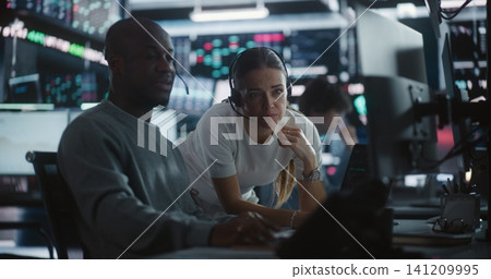 Female Financial Supervisor Mentoring Male Analyst at Stock Exchange Station Female Financial Supervisor Mentoring Male Analyst at Stock Exchange Station 141209995