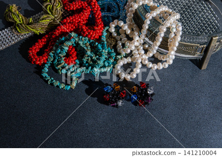 Beaded Jewelry and Earrings. Bohemian Jewelry on dark background Beaded Jewelry and Earrings. Bohemian Jewelry on dark background 141210004