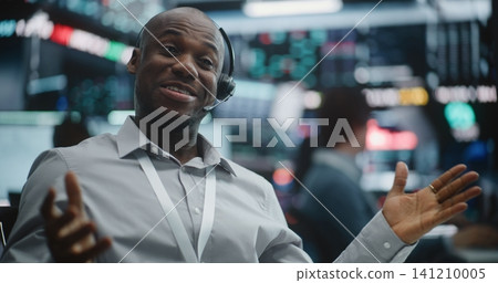 Triumphant Male Trader in Grey Shirt Shifts From Focused Data Analysis to Celebratory Mood Triumphant Male Trader in Grey Shirt Shifts From Focused Data Analysis to Celebratory Mood 141210005