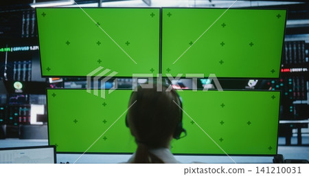 Professional Female Trader Working at Multi Monitor Setup With Green Screens in Stock Exchange Professional Female Trader Working at Multi Monitor Setup With Green Screens in Stock Exchange 141210031