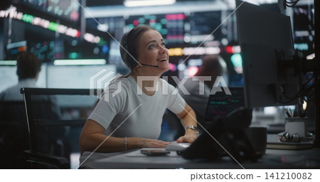 Relieved Female Trader Celebrating Profit Growth at Multi Monitor Workstation Relieved Female Trader Celebrating Profit Growth at Multi Monitor Workstation 141210082