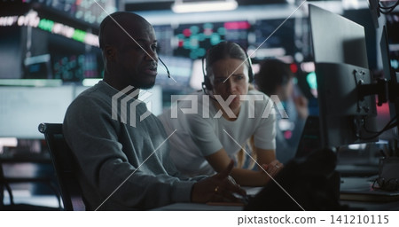 Female Financial Supervisor Mentoring Male Analyst at Stock Exchange Station 141210115
