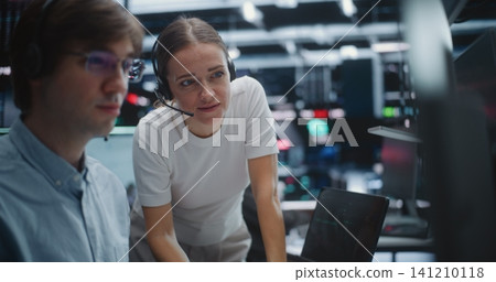 Male and Female Brokers Analyzing Real Time Stock Data Together Male and Female Brokers Analyzing Real Time Stock Data Together 141210118