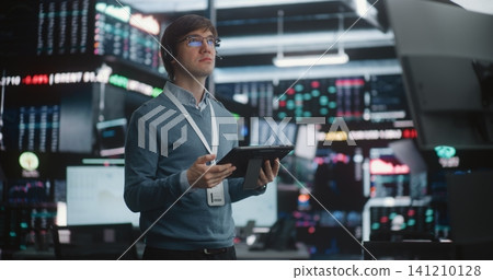 Man in Glasses Holds Digital Tablet, Looking Up Large Data Displays Man in Glasses Holds Digital Tablet, Looking Up Large Data Displays 141210128