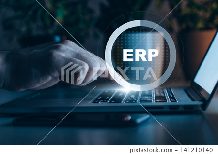 Working on ERP software using a laptop at home during evening hours Working on ERP software using a laptop at home during evening hours 141210140