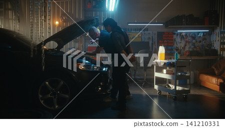 Female Technician and Male Colleague Measure Engine Oil Level Using Dipstick Female Technician and Male Colleague Measure Engine Oil Level Using Dipstick 141210331