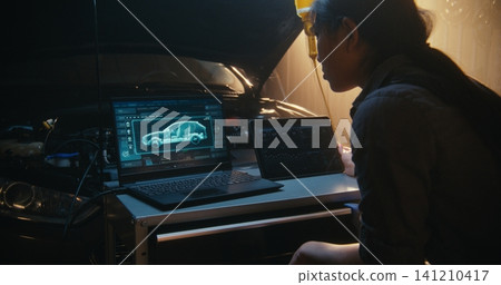 Female Mechanic Monitoring 3D Vehicle Simulation and Performance Logs on Multiple Devices 141210417
