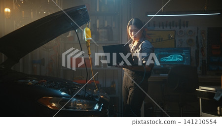 Woman Mechanic Troubleshooting Car Engine Issues With Diagnostic Software Woman Mechanic Troubleshooting Car Engine Issues With Diagnostic Software 141210554