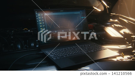 Laptop Screen, Positioned Right Next Car Engine, Displays Telemetry, Graphs, Lines System Code Laptop Screen, Positioned Right Next Car Engine, Displays Telemetry, Graphs, Lines System Code 141210566