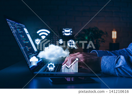Working on software development for cloud services and data analytics with a laptop at night Working on software development for cloud services and data analytics with a laptop at night 141210616