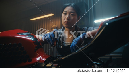 In Garage, Young Mechanic Pauses Beside Motorcycle, Thinking Intensely About How Fix Malfunction In Garage, Young Mechanic Pauses Beside Motorcycle, Thinking Intensely About How Fix Malfunction 141210621