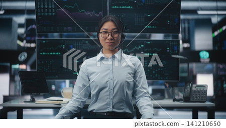 Businesswoman in Futuristic Stock Exchange Office Surrounded By Digital Trading Screens Businesswoman in Futuristic Stock Exchange Office Surrounded By Digital Trading Screens 141210650