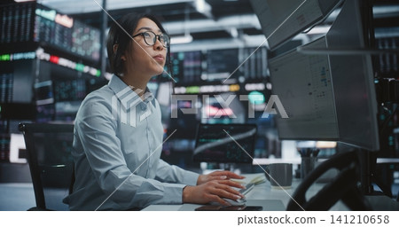 Woman Analyzes Financial Charts on Multiple Monitors and Tablet Execute Buy and Sell Orders Woman Analyzes Financial Charts on Multiple Monitors and Tablet Execute Buy and Sell Orders 141210658