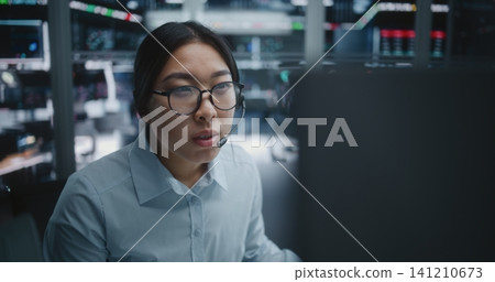Female Stock Broker Consulting Via Headset While Monitoring Market Analytics Female Stock Broker Consulting Via Headset While Monitoring Market Analytics 141210673